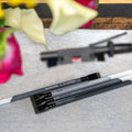 Blackwing Neolucida pencils by BIG IDEA DESIGN LLC in firm balanced and soft graphite grades lying on a textured surface