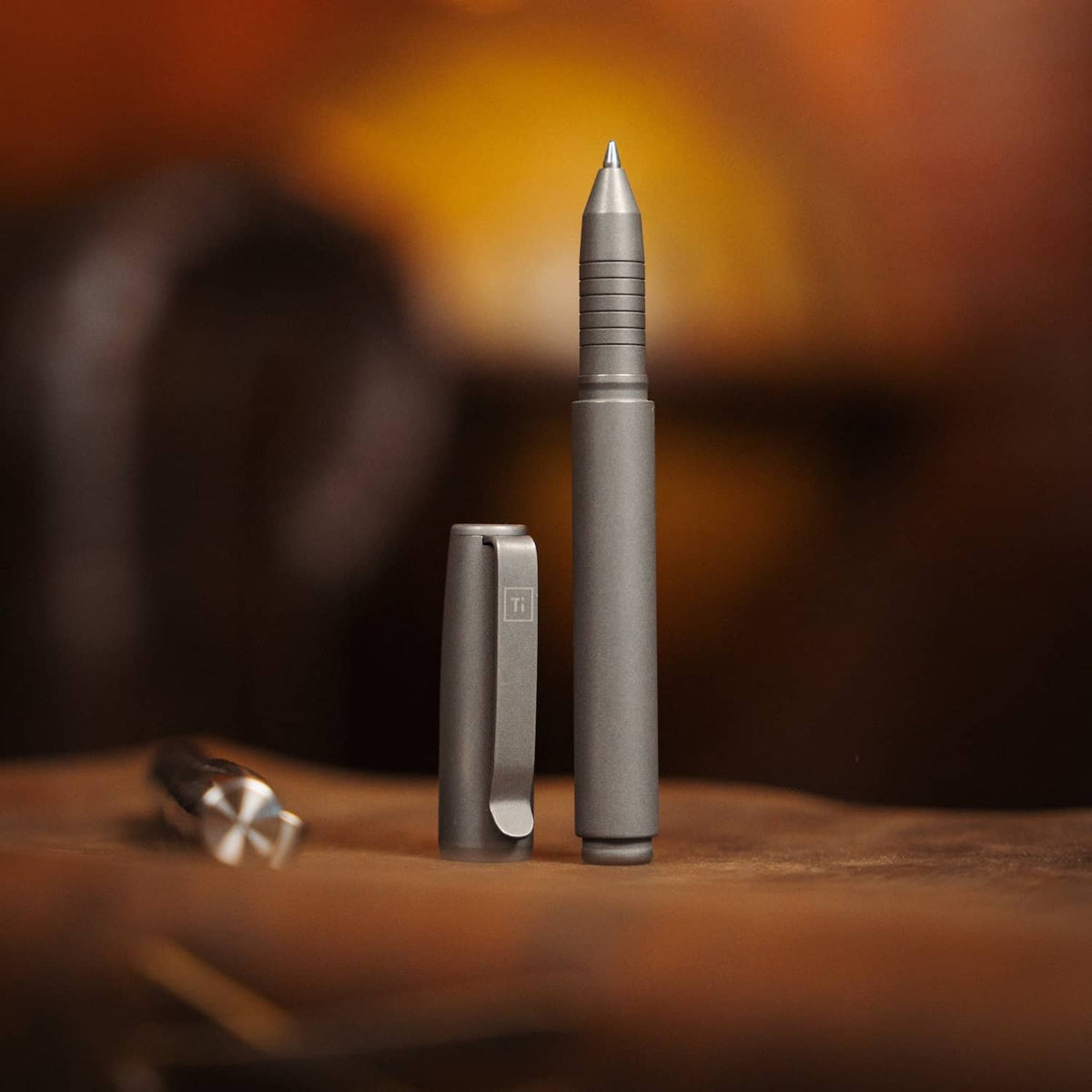 BIG IDEA DESIGN LLC titanium capped pen with matte finish and durable metal clip on wooden surface