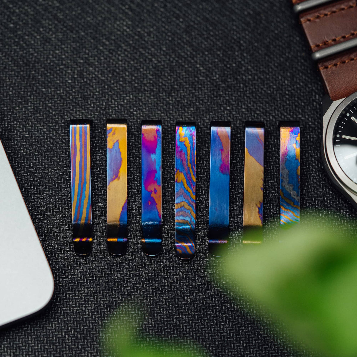 Set of colorful Titanium Damascus pen clip designs with unique patterns by Big Idea Design LLC