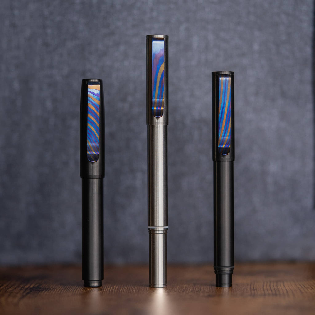 Big Idea Design LLC sleek pens featuring a Titanium Damascus pen clip with colorful pattern accents