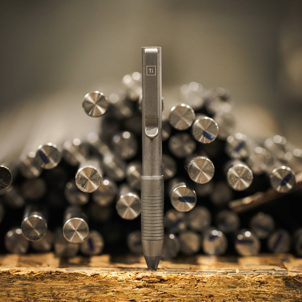 USA Ti Pocket Pro Precision Titanium Pen on a Metal Workshop Background